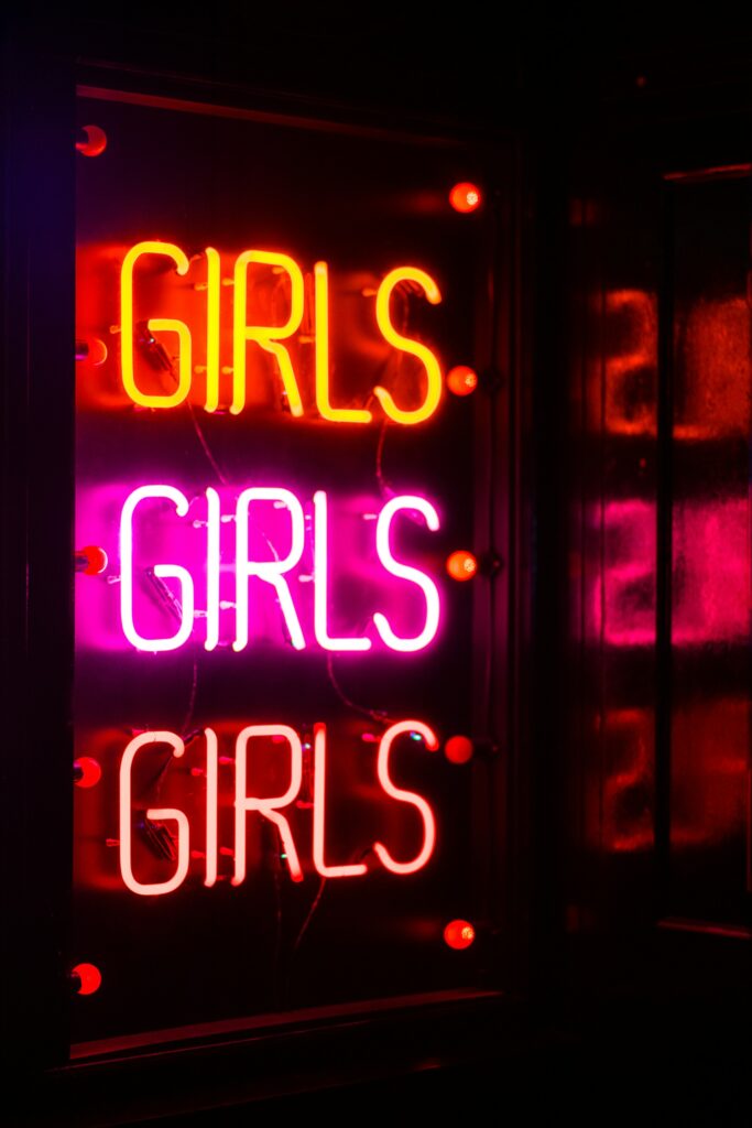 neon sign saying girls girls girls